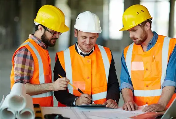 A group of retrofit coordinators looking at plans.