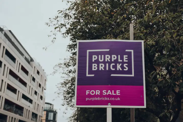 Building with a for sale board outside highlighting the need for an EPC when selling