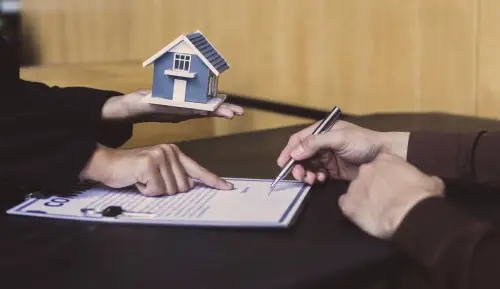 Mortgage documents and certificate on a desk showing the link between EPC house price and buyer financing